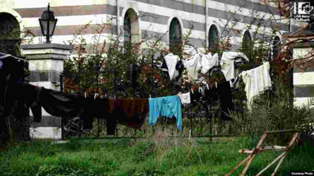 Wet clothes hanging out to dry outside the Khalid Ben Walid mosque in Al-Kaldeeya, Homs, Syria, February 8, 2013 (Lens Young Homsi)