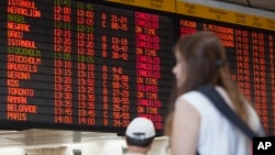 A departure flight board displays various canceled and delayed flights in Ben Gurion International airport a day after the U.S. Federal Aviation Administration imposed a 24-hour restriction on flights to the airport in Tel Aviv, Israel, July 23, 2014. 