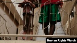 Two asylum-seeking boys stand on a staircase while detained at Belawan Immigration Detention Center, September 2012. (HRW/Kyle Knight photo) 