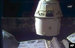 FILE - In this frame grab taken from NASA Television, a SpaceX Dragon capsule separates from a robotic arm of the International Space Station en route back to Earth with a load of science experiments and gear from the space station, Aug. 26, 2016.