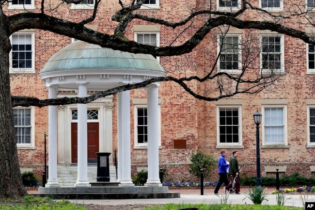Mahasiswa memindahkan barang-barang di kampus di University of North Carolina di Chapel Hill, N.C., 18 Maret 2020. (Foto: AP)