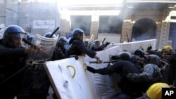 Demonstrators protesting against Italian premier Mario Monti's labor reforms, clash with police as Monti participates in a meeting in Bologna, Italy, June 16, 2012.