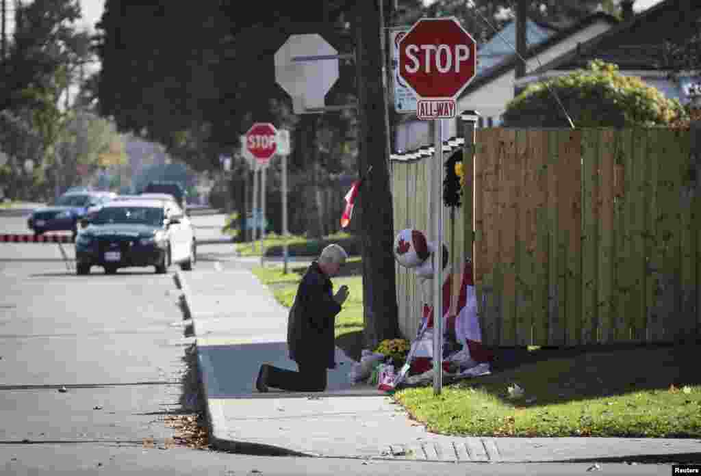 Paul Murdock prays at a makeshift memorial in honor of Cpl. Nathan Cirillo, outside the Cirillo family home in Hamilton, Ontario, Oct. 24, 2014. 