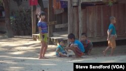 Karen children play a game in front of a local home in the town of Shwe Koko in Karen state, Myanmar.