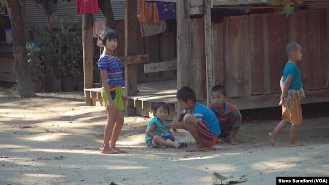 Karen children play a game in front of a local home in the town of Shwe Koko in Karen state, Myanmar.