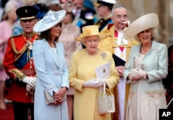 FILE - In this April 29, 2011 file photo, from left, Prince Phillip, Carole Middleton, Queen Elizabeth II and Camilla, Duchess of Cornwall stand outside of Westminster Abbey after the Royal Wedding of Prince William and Kate Middleton in London.