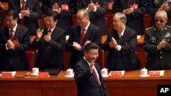 FILE - Chinese President Xi Jinping arrives for the opening session of China's 19th Communist Party Congress at the Great Hall of the People in Beijing, Oct. 18, 2017.