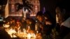 FILE - Indian Christians light candles at a Sacred Heart Cathedral on the eve of Christmas in New Delhi, India, Wednesday, Dec. 24, 2014.