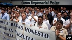 Polar workers who fear losing their jobs protest outside company headquarters in Caracas, Venezuela, Friday, April 22, 2016. Polar, the largest producer of beer in the country, said Thursday the lack of imported raw materials.