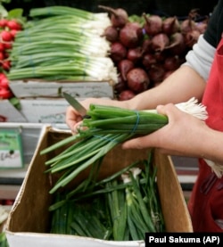 These are bunches of scallions. They are also called green onions.