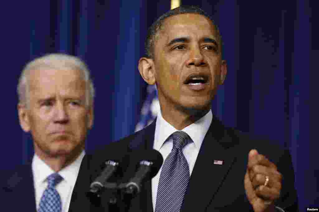 US President Barack Obama (R) unveils a series of proposals to counter gun violence as Vice President Joe Biden looks on during an event at the White House in Washington, January 16, 2013. 