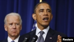 US President Barack Obama (R) unveils a series of proposals to counter gun violence as Vice President Joe Biden looks on during an event at the White House in Washington, January 16, 2013.
