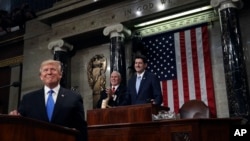 President Donald Trump pauses as delivers his first State of the Union address in the House chamber of the U.S. Capitol to a joint session of Congress, Jan. 30, 2018 in Washington. (Win McNamee/Pool via AP)