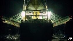 In this July 2021 photo provided by Sea Shepherd, a Chinese-flagged ship fishes for squid at night on the high seas off the west coast of South America.