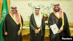 (L-R) Saudi Crown Prince Mohammed bin Nayef, Saudi King Salman, and Saudi Arabia's Deputy Crown Prince Mohammed bin Salman stand together as Saudi Arabia's cabinet agrees to implement a broad reform plan known as Vision 2030 in Riyadh, April 25, 2016.