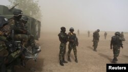 Des militaires camerounais de la Brigade d'intervention rapide assurent la sécurité près d’un hélicoptère à Kolofata, Cameroun, 16 mars 2016. 