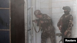 Afghan security forces take position at the scene of an attack on the Indian consulate in Herat province, May 23, 2014.