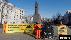 Greenpeace activists attend a protest in Moscow, Feb. 19, 2019, against a so-called "whale prison," where white whales and orcas are held in cages in the Russian Far East. Banners read: "Freedom to orcas and white whales."