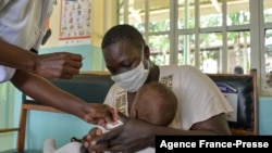 FILE: A child gets a malaria vaccination in Yala, Kenya, on 10.7.2021
