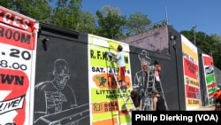 Cory Stowers (bottom right) and members of the ArtBloc organization work on a mural in Southeast D.C.