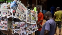 Bystanders read newspapers on a stall in Onitsha, Anambra State, southeastern Nigeria, on Nov. 5, 2021.
