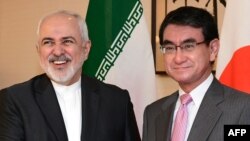 Iranian Foreign Minister Mohammad Javad Zarif, left, and his Japanese counterpart Taro Kono pose for the media before their talks at the foreign minister's audience room in Tokyo, May 16, 2019.