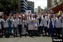 Workers of the health sector and opposition supporters take part in a protest against President Nicolas Maduro's government in Caracas, Venezuela May 17, 2017.