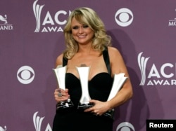Miranda Lambert poses with her awards for female vocalist of the year, song of the year, and single record of the year backstage at the 48th ACM Awards in Las Vegas, April 7, 2013.
