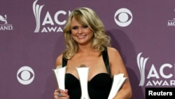 Miranda Lambert poses with her awards for female vocalist of the year, song of the year, and single record of the year backstage at the 48th ACM Awards in Las Vegas, April 7, 2013.