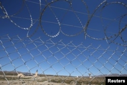 The installations of a Chinese space station are seen behind a fence in Las Lajas, Argentina, January 22, 2019. (REUTERS/Agustin Marcarian)