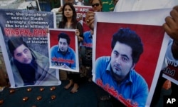 FILE - Members of a Pakistani civil society demonstrate April 22, 2017, in Karachi, Pakistan, against the killing of Mashal Khan, a student at the Abdul Wali Khan University in the northwestern city of Mardan. Police say the lynching of Khan, falsely accused of blasphemy, was organized by other students who saw him as a political rival.
