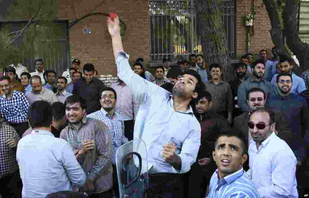 An Iranian protester throws a tomato at the embassy of Saudi Arabia in Tehran, Sept. 27, 2015.