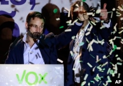 Santiago Abascal, leader of far right party Vox, gestures supporters gathered outside the party headquarters following the general election in Madrid, Sunday, April 28, 2019.