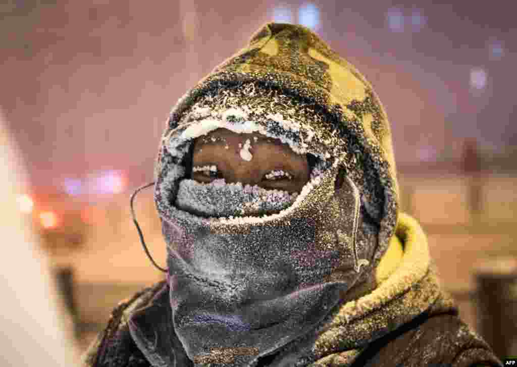 An artist stands while working on an ice piece on a street of the eastern Siberian city of Yakutsk, where air temperature were 40 degrees below zero.