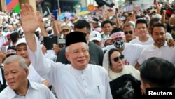 FILE - Former Malaysian Prime Minister Najib Razak and his wife, Rosmah Mansor, attend the Anti-ICERD (International Convention on the Elimination of All Forms of Racial Discrimination) mass rally in Kuala Lumpur, Malaysia, Dec. 8, 2018.