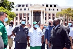 South African President Cyril Ramaphosa inspects damages after a fire broke out at the Parliament building in Cape Town, Jan. 2, 2022. (Elmond Jiyane/GCIS/Handout via Reuters)