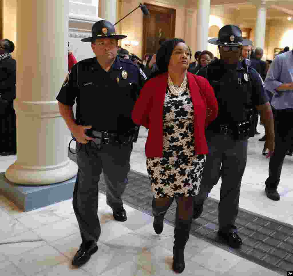 Sen. Nikema Williams (D-Atlanta) is arrested by capitol police during a protest over election ballot counts in the rotunda of the state capitol building, in Atlanta, Georgia, Nov. 13, 2018.