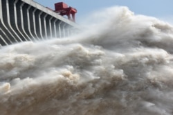 The Three Gorges dam on the Yangtze river discharges water to lower the water level in the reservoir following heavy rain and floods across the country, in Yichang, Hubei province, China July 15, 2018.
