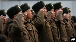 FILE - North Korean soldiers salute before the statues of North Korea's late leader Kim Jong Il, and his father, North Korea's founder Kim Il Sung, in Pyongyang, North Korea, Feb. 16, 2014.