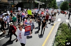 Protesters march through downtown Atlanta to the NRA's annual convention where President Donald Trump was the featured speaker, April 28, 2017.