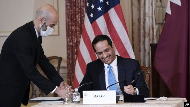 Qatar's Foreign Minister Sheikh Mohammed bin Abdulrahman Al Thani and Secretary of State Antony Blinken, not pictured, participate in a signing ceremony at the State Department in Washington, Friday, Nov. 12, 2021.