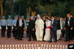 Pope Francis, center, visits the National Martyrs' Memorial of Bangladesh in Savar, outskirts of Dhaka, Bangladesh, Nov. 30, 2017.