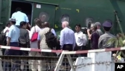 In this image made from video, U.N. Security Council ambassadors board a helicopter to fly to Maungdaw district of Rakhine State, in Sittwe, Myanmar, Tuesday, May 1, 2018.