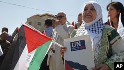 Palestinian activist Latifa Abu Hmeid holds a letter addressed to the UN Secretary-General Ban Ki-moon in front of the UN headquarters in the West Bank city of Ramallah, September 8, 2011.