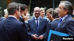 Belgian Prime Minister Charles Michel, center, stands among EU leaders at his first European Union summit in Brussels, Oct. 23, 2014. 