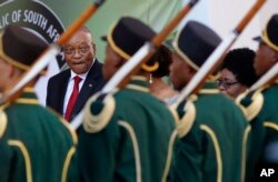 South African President Jacob Zuma, background left, reviews the guard of honor at Parliament in Cape Town, South Africa, Feb. 9, 2017, South African police and military forces on Thursday deployed ahead of Zuma's annual speech before lawmakers.