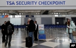 Transportation Security Administration officers work at a checkpoint at O'Hare airport in Chicago, Jan. 11, 2019. This weekend the government shutdown likely stretches on to become the longest in American history.
