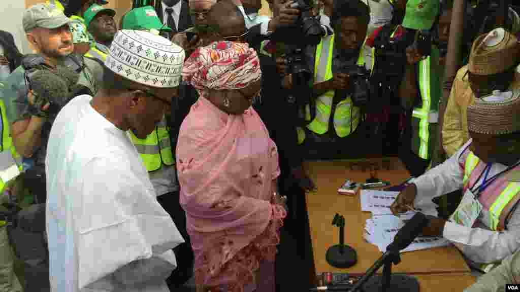 General Muhammadu Buhari, the presidential candidate of the opposition APC political party, and his wife, Aishatu Buhari, are accredited at their polling unit in Daura, Katsina state, March 28, 2015.