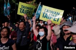 Supporters of the ruling Democratic Progressive Party react during a campaign rally for the local elections, in Taipei, Taiwan, Nov. 21, 2018.