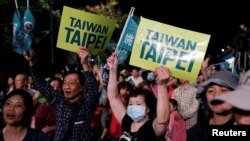 Supporters of the ruling Democratic Progressive Party react during a campaign rally for the local elections, in Taipei, Taiwan, Nov. 21, 2018.